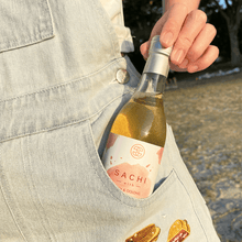 Load image into Gallery viewer, Sachi Soy Wine Peach and Oolong in a beach
